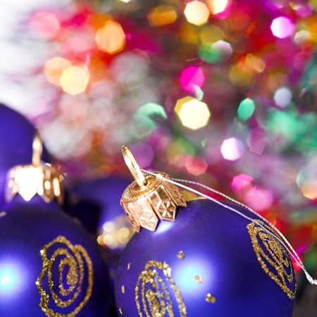Blue christmas baubles with blured lights in backgroundの写真素材