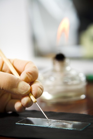researcher's hand with long needleの写真素材