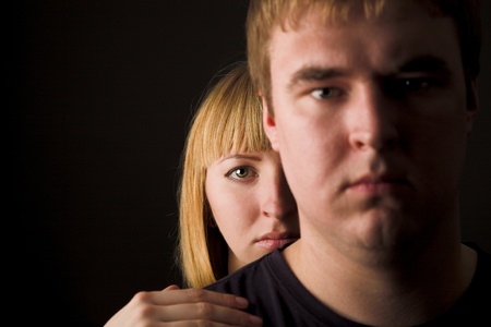 Young couple isolated on black. Woman behind man. DOFの写真素材