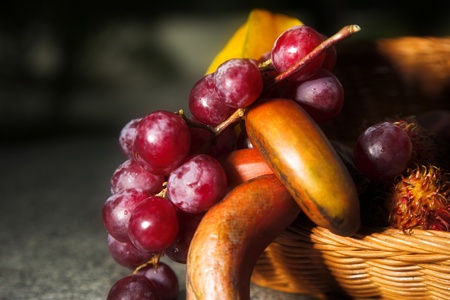 Rambutan, banana and grapes. Still life with tropical fruitsの写真素材