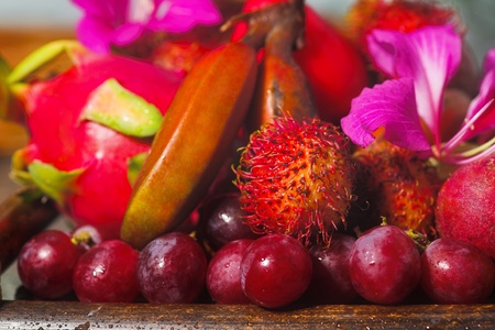 different tropical fruits - rambutan, bananas and grapesの写真素材