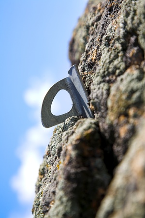 climbing iron in the rock against blue skyの写真素材