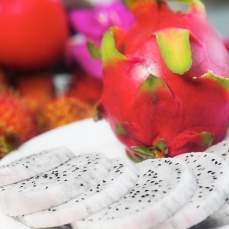 tropical fruit. Sliced dragon fruit, rambutan and flower の写真素材
