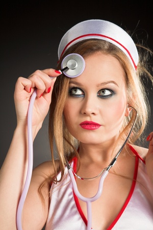 young beauty sexual nurse on black backgroundの写真素材