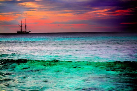 sailing ship silhouette on dramatic colored sky