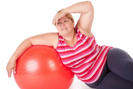 tired fat woman with big red gymnastic ballの写真素材
