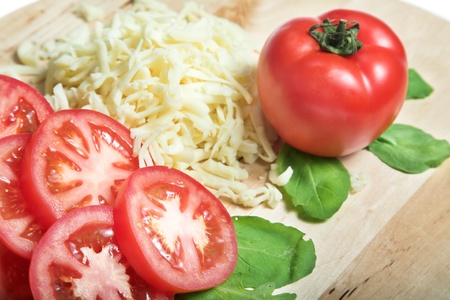 tomato and cheese on the wood plateの写真素材