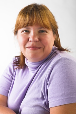 portrait of smiling overweigth woman on gray backgroundの写真素材