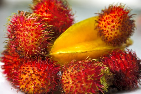 tropical fruits. still life with rambutans and carambola