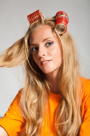 young beauty woman with hair-rollersの写真素材