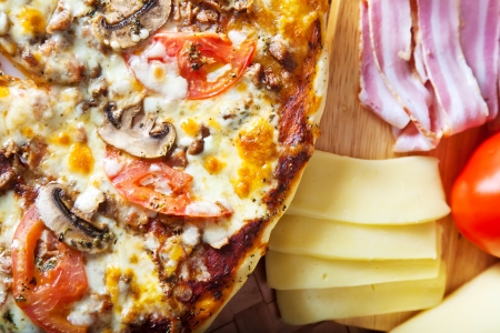 pizza with red tomato cheese and porkの写真素材