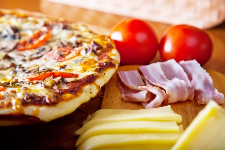pizza with red tomato cheese and porkの写真素材
