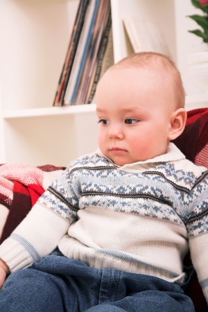 funny boy sitting on the sofaの写真素材