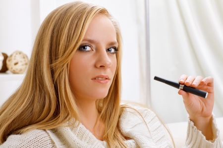 young beauty girl with e-cigaretteの写真素材
