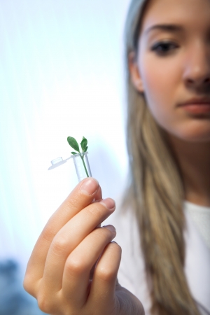 beauty woman holding green plant in laboratory tubeの写真素材