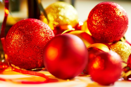 Red and gold christmas balls on decorative backgroundの写真素材
