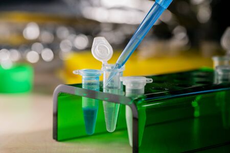 Scientist Pouring Liquid Into Test Tube 