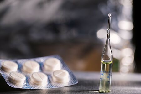 Pills, Syringe And Ampoule With Vaccination On Dark Tableの写真素材