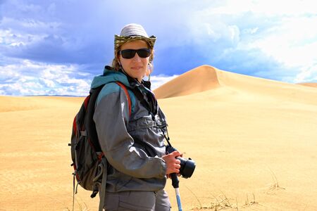 Tourist walking along the edge of the sand dune. Large barkhan in Mongolia sandy dune desert Mongol...