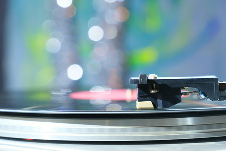 Vinyl record player, bright lights disco-bokeh.