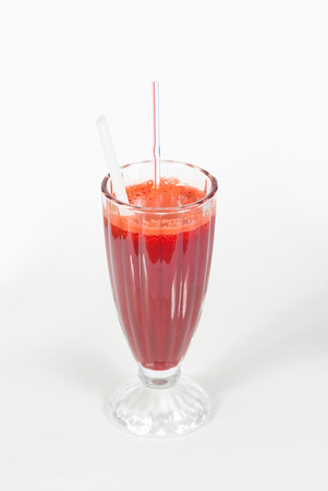 fruit cocktail in a cup with a straw on a white background2の写真素材
