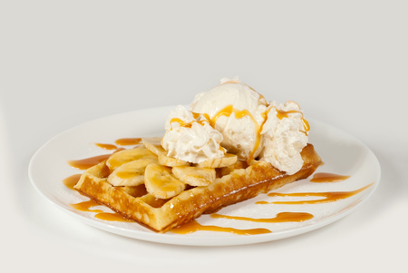 Belgian waffles on a white background with dessertの写真素材