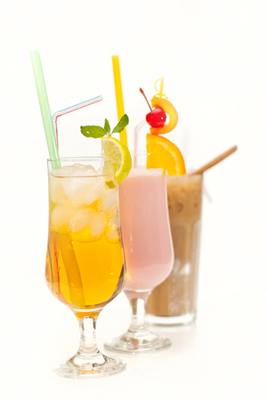 fruit cocktail in a cup with a straw on a white backgroundの写真素材