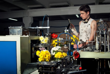 Flowers on the production of machines at the factory with the control engineerの写真素材