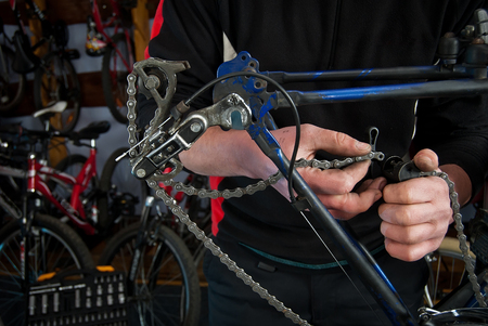 Master bike repairs workshop in their own handsの写真素材