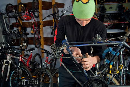 Master bike repairs in the workshop with tools in handの写真素材