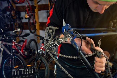 Master bike repairs in the workshop with tools in handの写真素材