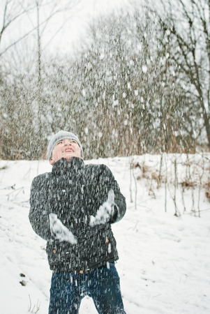 the guys are playing in the snow in the winter with emotionsの写真素材