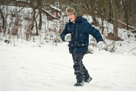 the guys are playing in the snow in the winter with emotionsの写真素材