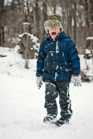 the guys are playing in the snow in the winter with emotionsの写真素材