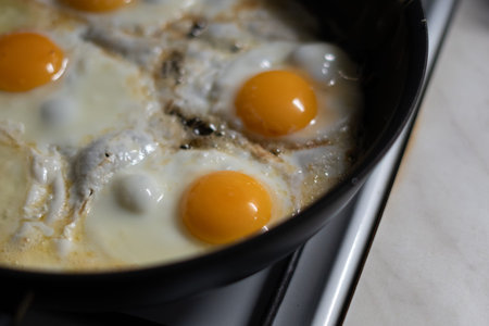 Fried eggs in a frying pan on the stove. Close-upの写真素材