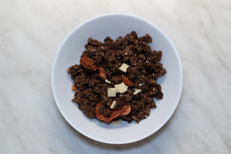 cereals in a white plate on a marble background, top viewの写真素材