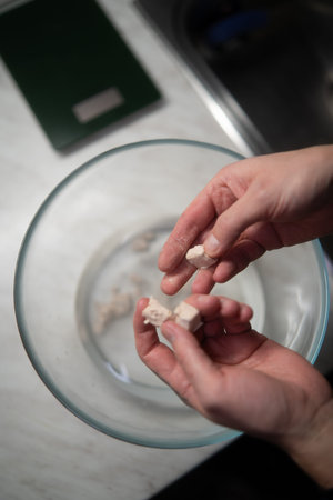 Close-up Of Person's Hand Inserting On Table