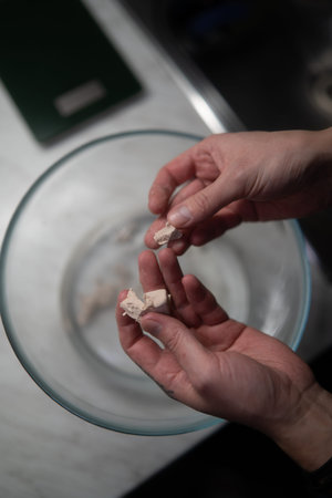 A man's hand holds a piece of chalk in his hand.の写真素材