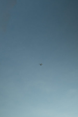 Airplane flying in the blue sky. Airplane in the sky.