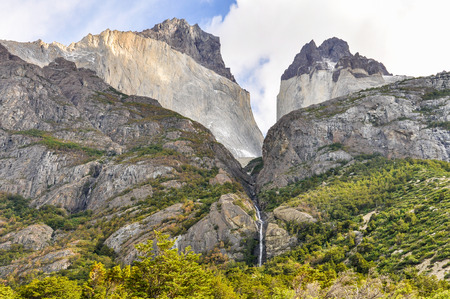 A waterfall between two peaks in the Torres del Paine National Park, Patagonia, Chileの写真素材