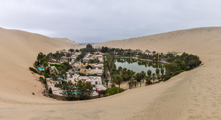 The oasis between the dunes of Huacachina in the coastal desert of Peruの写真素材