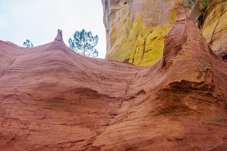 Colorful rocks made of ochre near the hilltop village of Rousillon, Provence, France