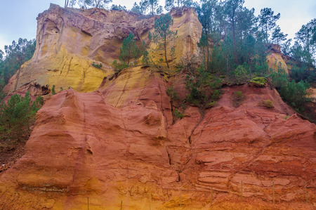 Colorful rocks made of ochre near the hilltop village of Rousillon, Provence, Franceの写真素材