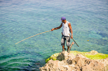 Fisherman catching octopus in the Malecon in Havana, the capital of Cubaのeditorial素材