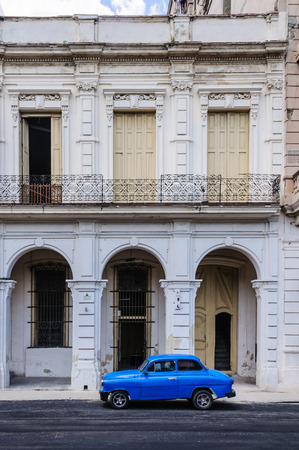 Blue car parking in front of old buildings in Paseo de Marti in Havana, the capital of Cubaのeditorial素材