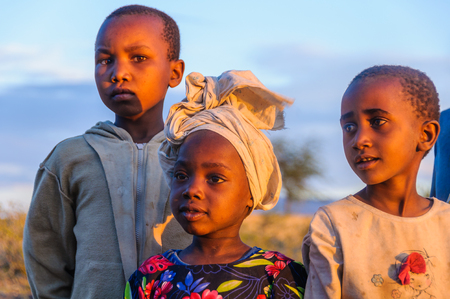 Kids from a Datoga tribe playing at sunset at Lake Eyasi, Tanzaniaのeditorial素材