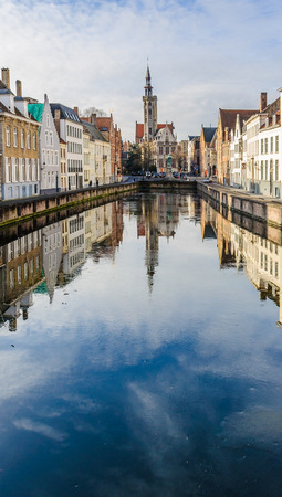 Reflection of church in Jan Van Eyckplein in the UNESCO World Heritage Old Town of Bruges, Belgiumの写真素材