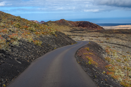 Road to infiinity in the volcanic Timanfaya National Park, Lanzarote, Spainの写真素材