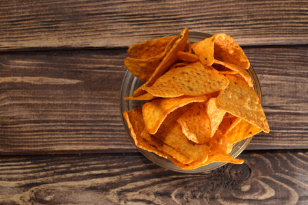 Potato chips in a bowl on wooden backgroundの写真素材