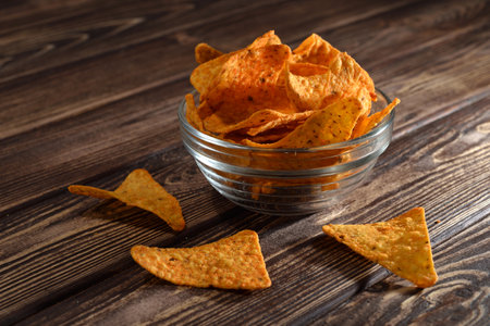 Potato chips in a bowl on wooden backgroundの写真素材